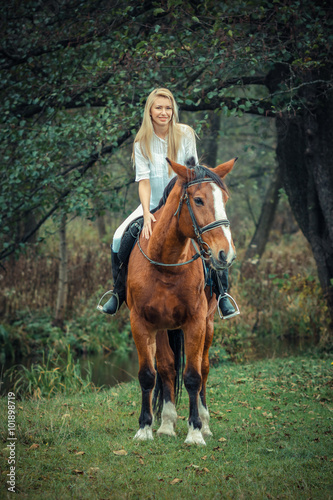 romantic sensual girl on a horse in the forest