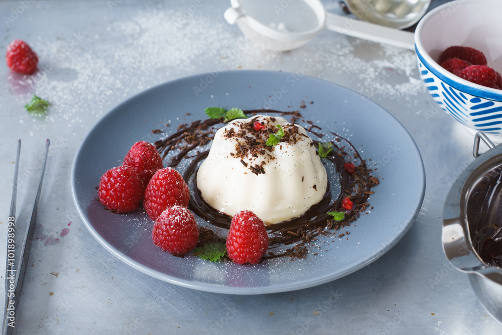 Vanilla panna cotta with chocolate sauce and fresh raspberries Vanilla panna cotta with chocolate sauce and fresh raspberries