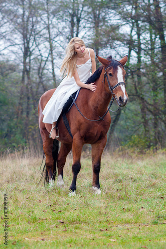 romantic sensual girl in white dress on a horse in the forest © ruslimonchyk