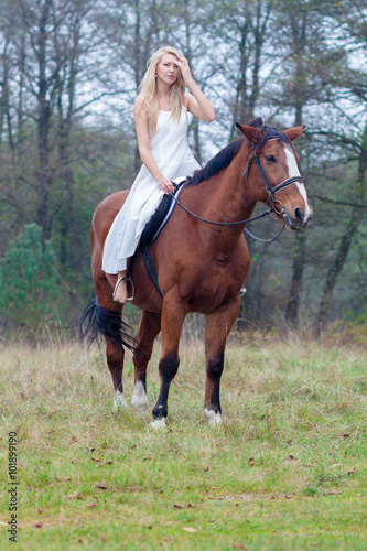 romantic sensual girl in white dress on a horse in the forest © ruslimonchyk