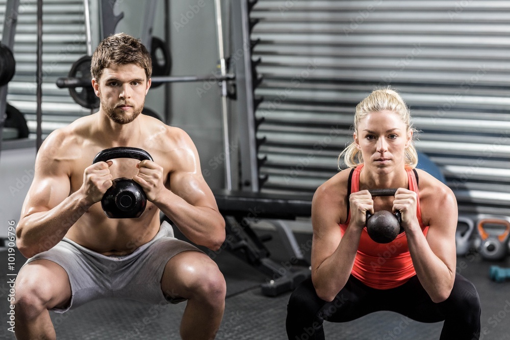 Fototapeta premium Couple lifting dumbbells together