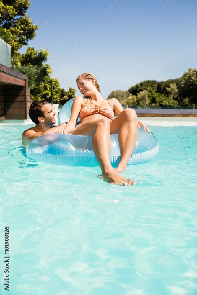 Happy couple with lilo in the pool