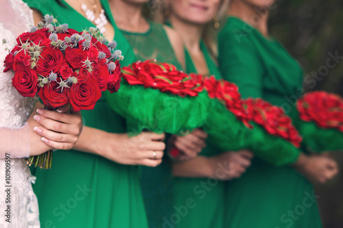 bride with a bouquet and bridesmaids