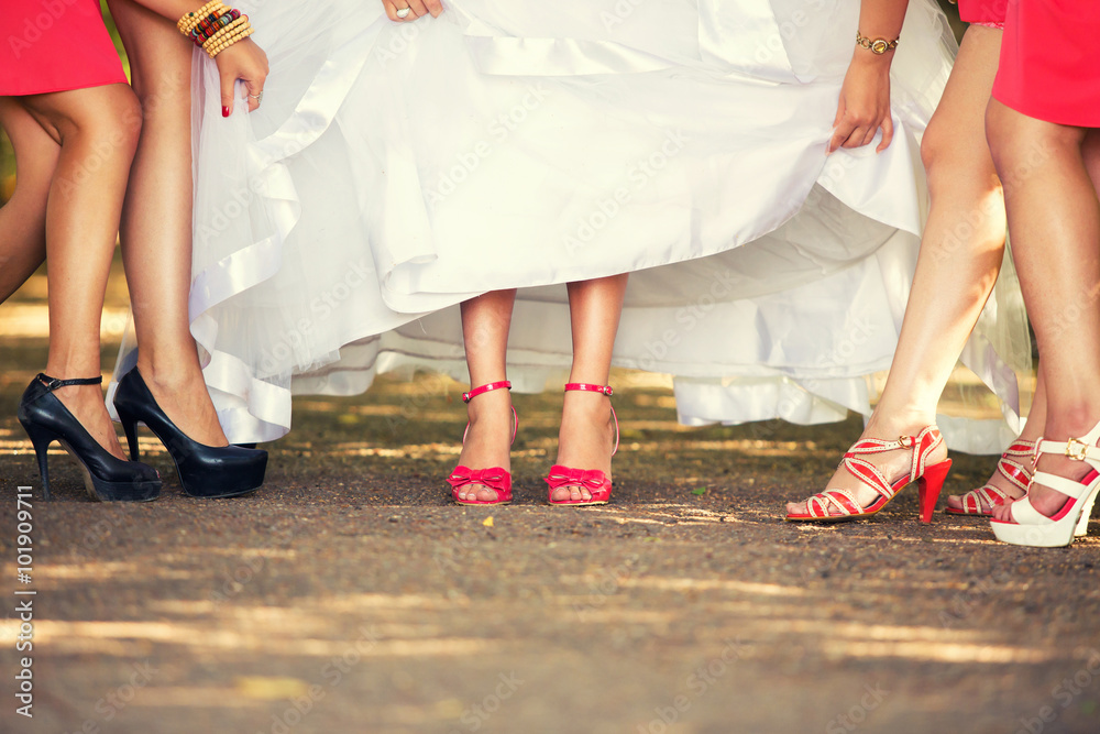 bride's feet in red shoes and her girlfriends