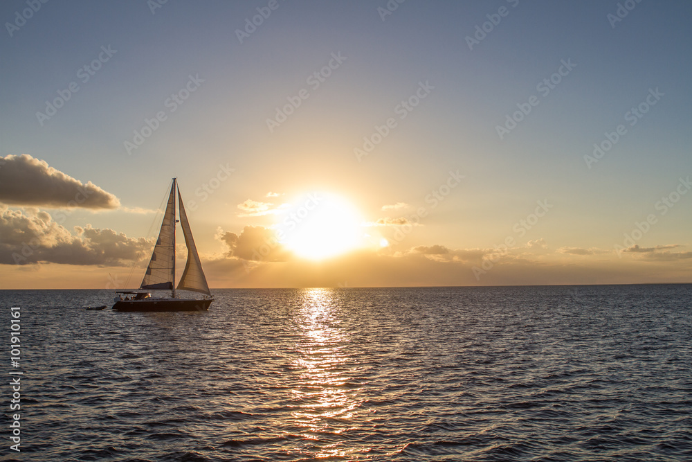 Yacht in the tropical sea at sunset