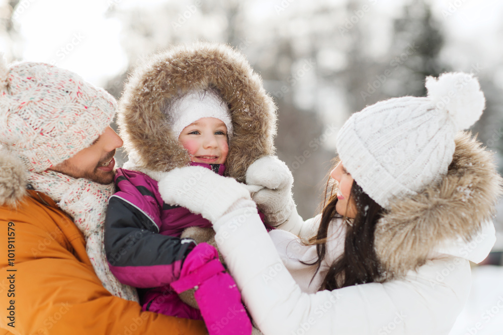 Obraz premium happy family with child in winter clothes outdoors