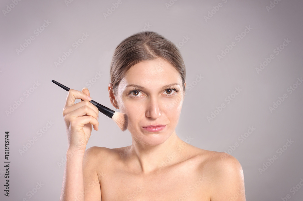 Young woman putting make-up Young woman putting make-up