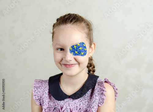 Little girl okluder on the eye. photo