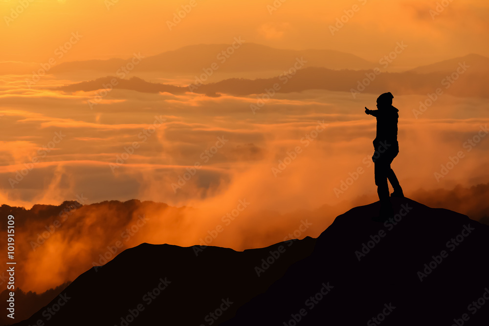 Silhouette of man standing on the top of mountain Silhouette of man standing on the top of mountain