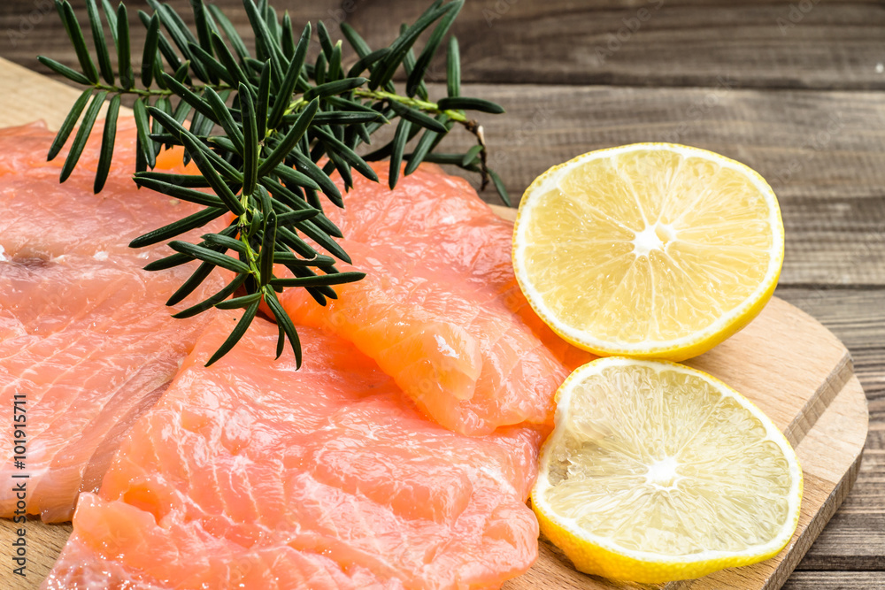 Raw salmon fillets with lemon slices, selective focus. Raw salmon fillets with lemon slices, selective focus.