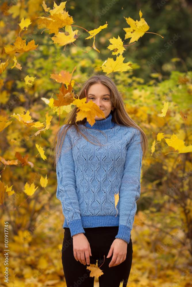 Young pretty woman walking in the autumn park Young pretty woman walking in the autumn park