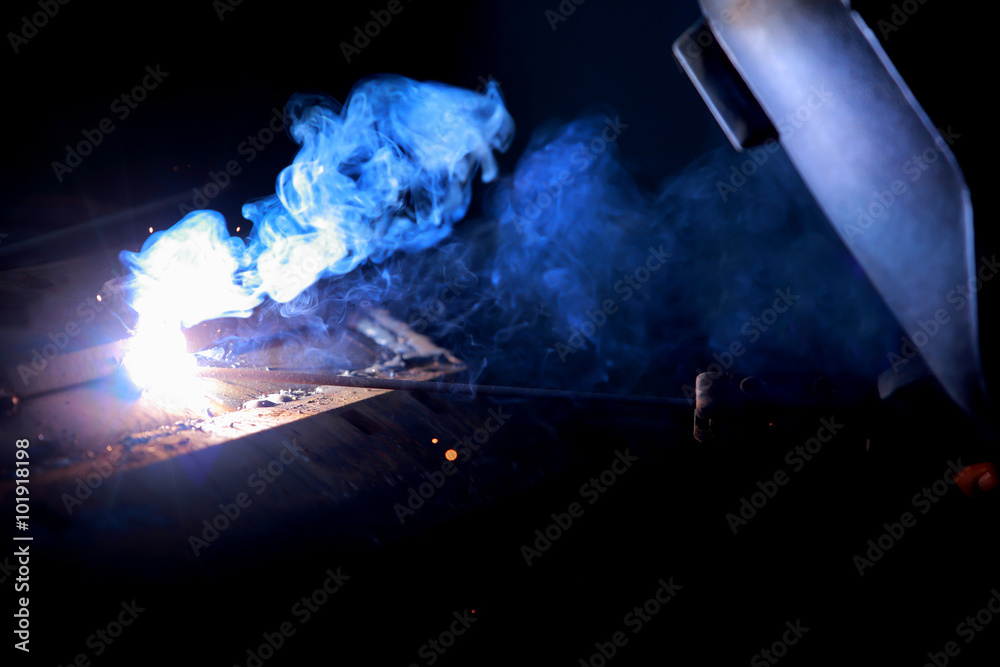 Close-up worker with protective mask welding metal. Close-up worker with protective mask welding metal.