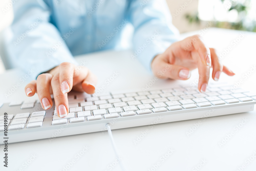 Woman office worker typing on the keyboard Woman office worker typing on the keyboard