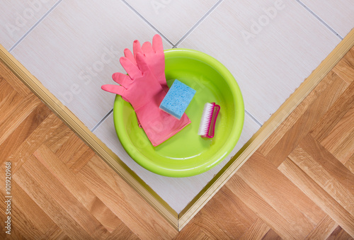 Washbasin with cleaning tools on the floor photo