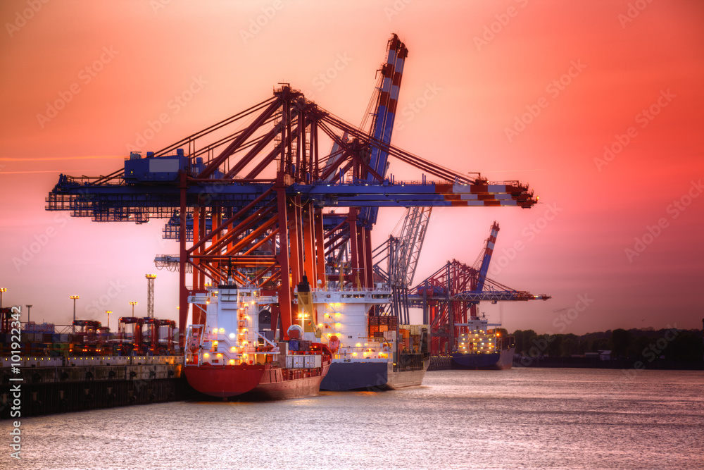 Container harbor in Hamburg, Germany. Night shoot with red sky.
