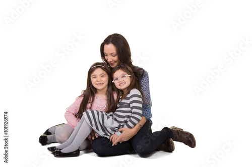 A mother and her daughters bonding isolated on white © Hogan Imaging