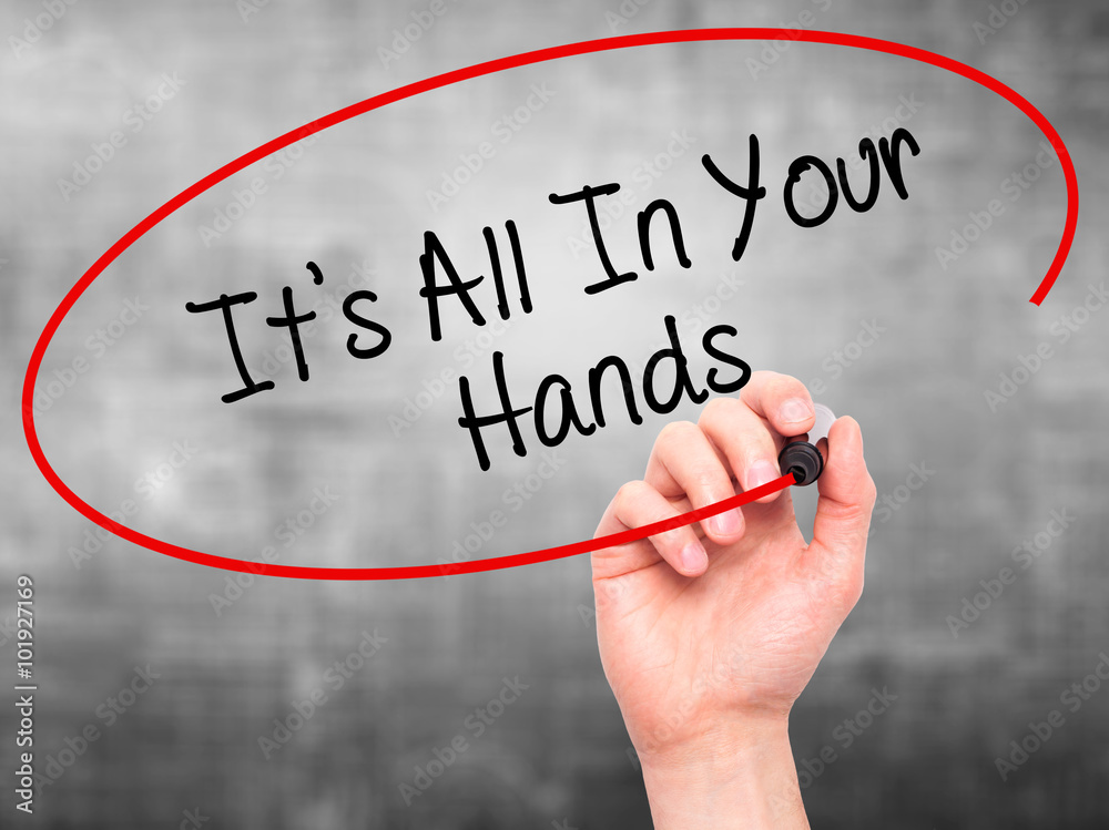 Man Hand writing It's All In Your Hands with black marker on vi Man Hand writing It's All In Your Hands with black marker on vi
