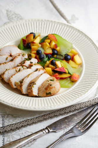 baked chicken fillet with fruit garnish