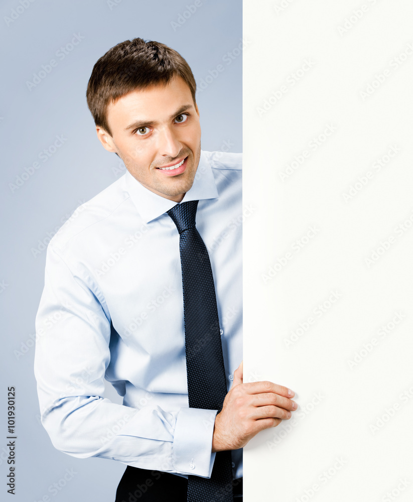Business man showing blank signboard, over grey Business man showing blank signboard, over grey