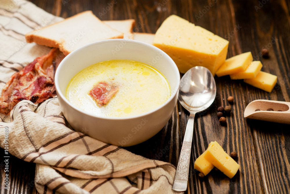 cheese soup with smoked pork ribs , potatoes, carrots , peppers , spices and bread on the wooden background
cheese soup with smoked pork ribs , potatoes, carrots , peppers , spices and bread on the wooden background