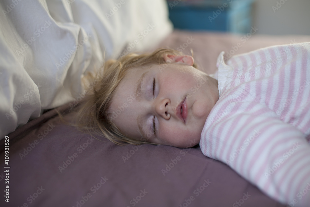 face of baby sleeping on king bed