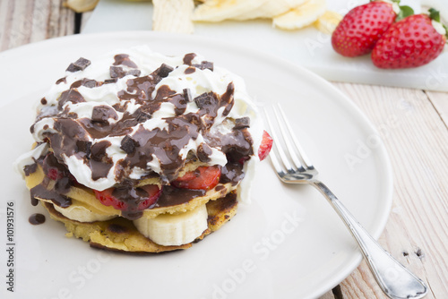 pancakes with strawberries, banana, blueberries and chocolate...
