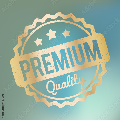 Premium Quality rubber stamp gold on a blue bokeh fog background.