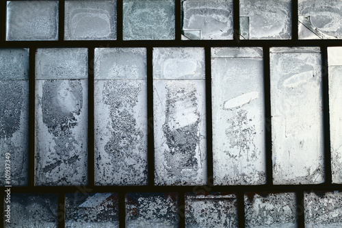 Vintage window frame with frozen ice figures