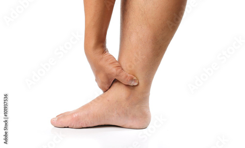 Hands are squeezed ankle atmosphere to spread the pain from his injuries on white background.
