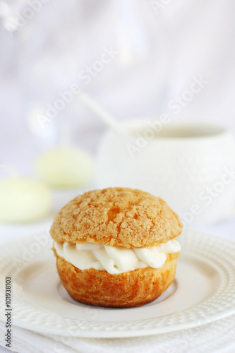 profiterole stuffed with cream on a white background