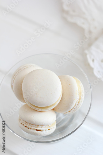 Four macaroon in a glass plate on a white background