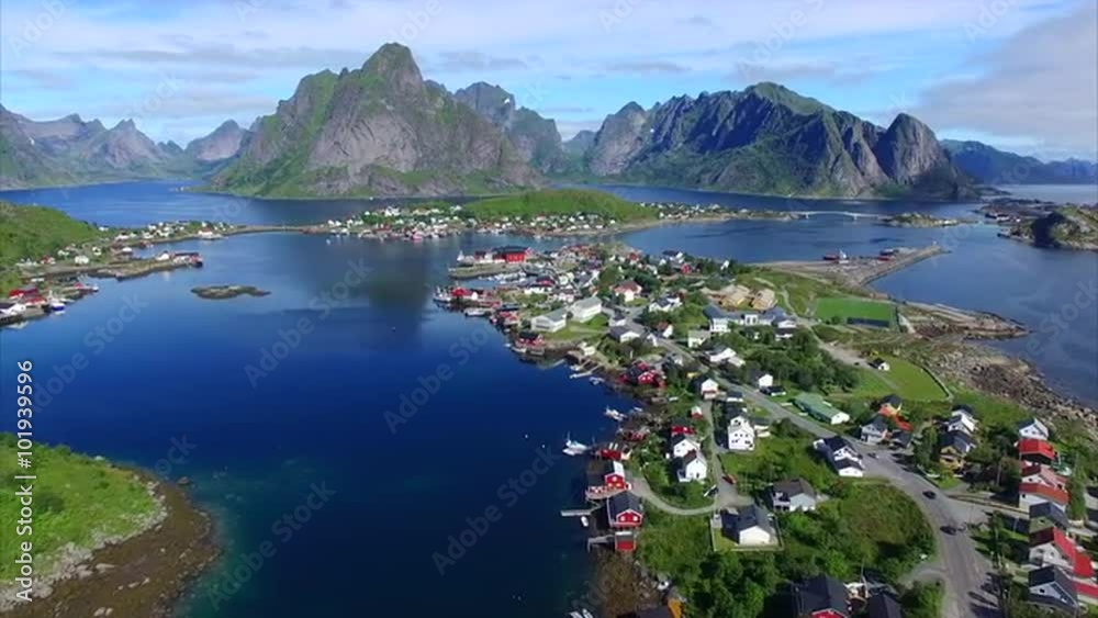 Aerial footage of beautiful town of Reine on Lofoten islands in Norway, popular tourist destination on sunny summer day. Aerial 4k Ultra HD.
