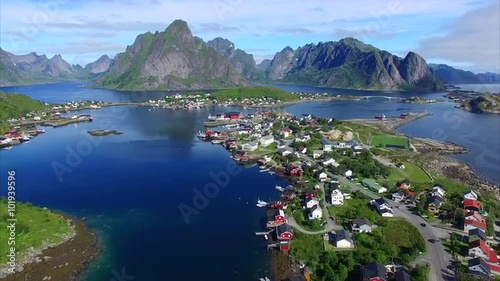 Aerial footage of beautiful town of Reine on Lofoten islands in Norway, popular tourist destination on sunny summer day. Aerial 4k Ultra HD.