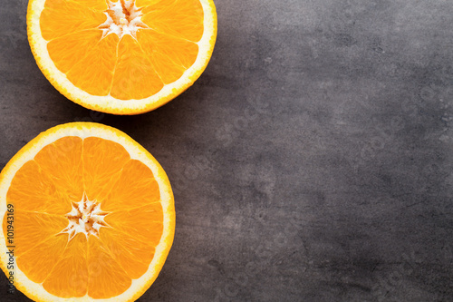 Orange slice on the grey background. © gitusik