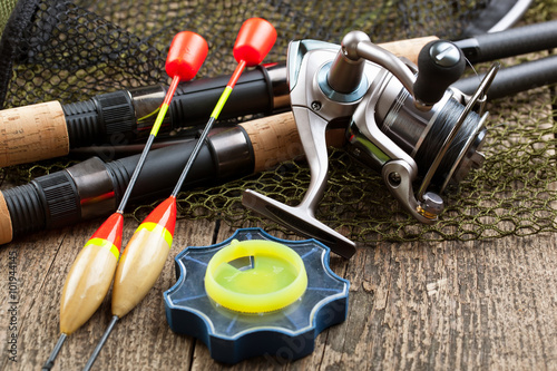 fishing tackle on a wooden table. toned image 