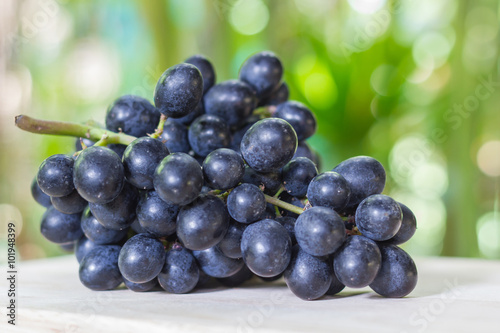 Black grapes on wooden