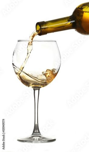 White wine pouring in glass, isolated on white