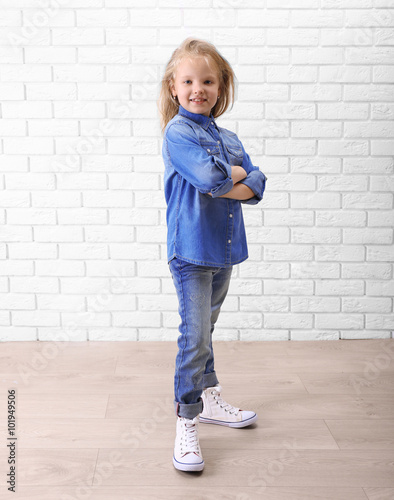 Little girl in jeans suit o...