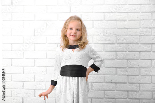 Little girl in dress on a w...