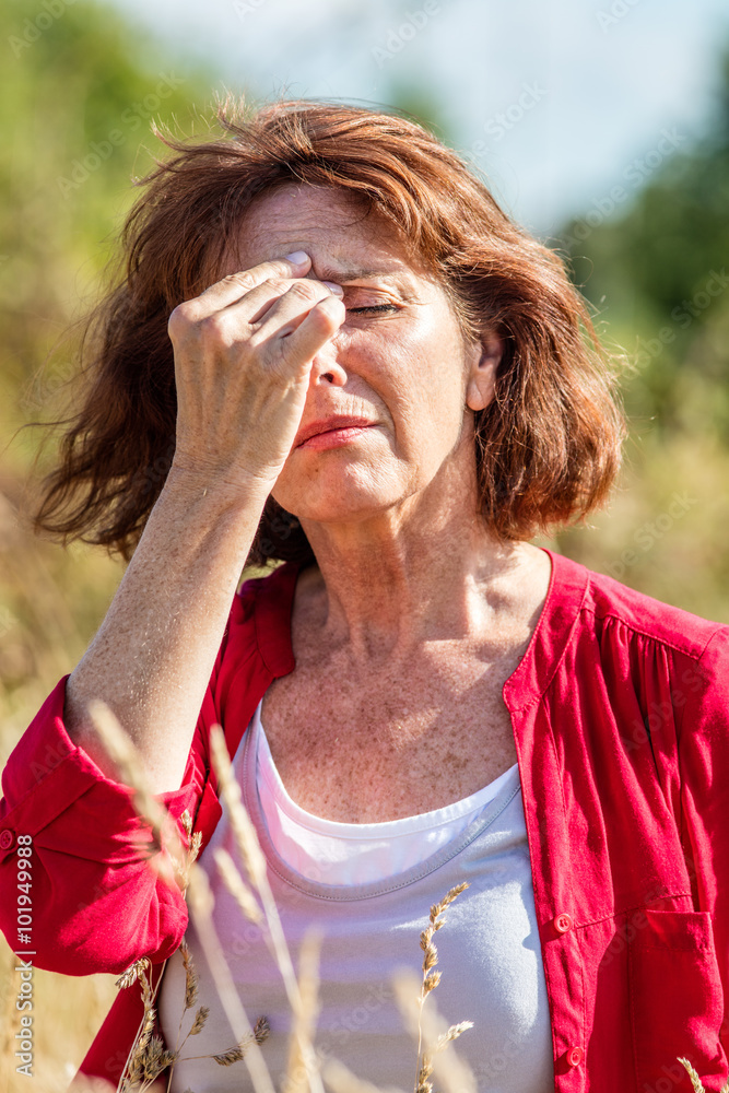 Εκτύπωση καμβά outdoors illness - gorgeous mature woman with freckles suffering from hot flashe