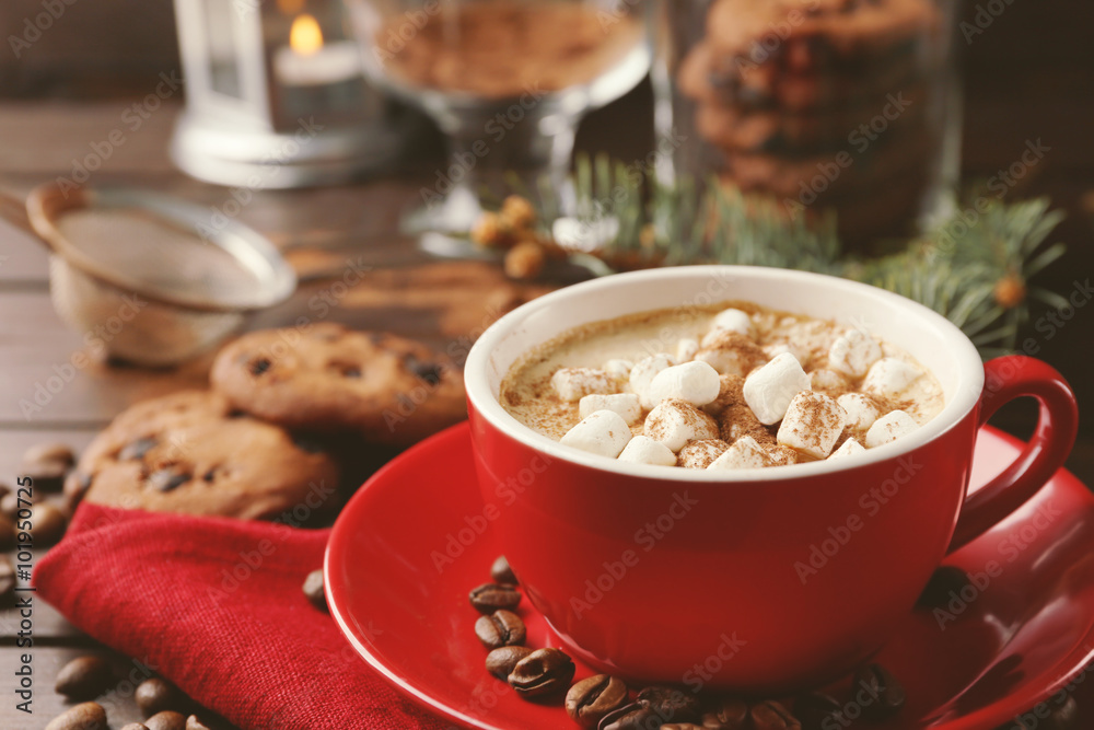 Mug of hot chocolate with marshmallows, fir tree branch on wooden background Mug of hot chocolate with marshmallows, fir tree branch on wooden background