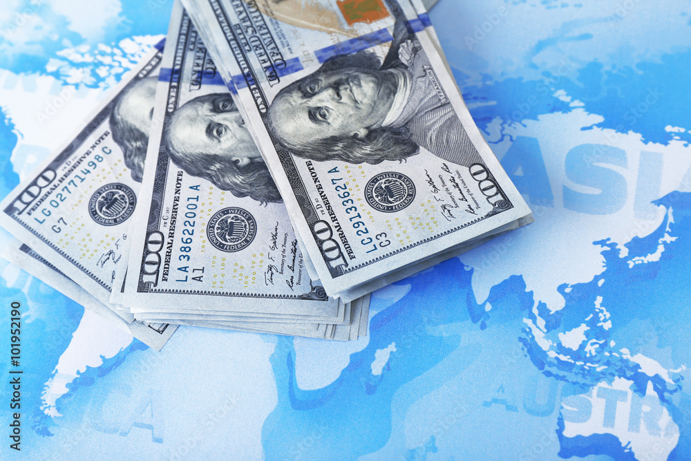 Fotografie Cash on the world map background, close up