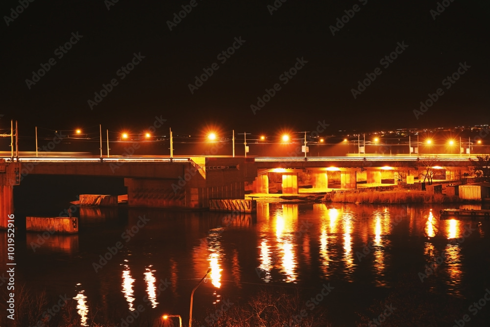 Lightened bridge across the river at night
