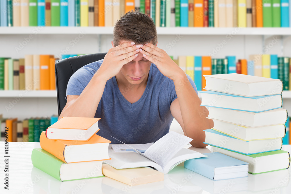 Tensed University Student Sitting In Library Tensed University Student Sitting In Library
