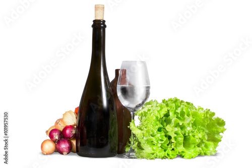 Group of various vegetables, greenery with water glass and bottl