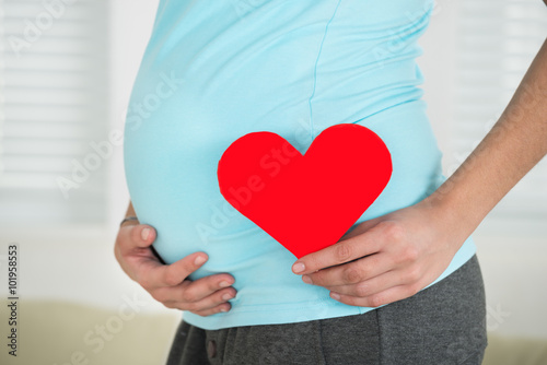 Pregnant Woman Holding Heart Shape