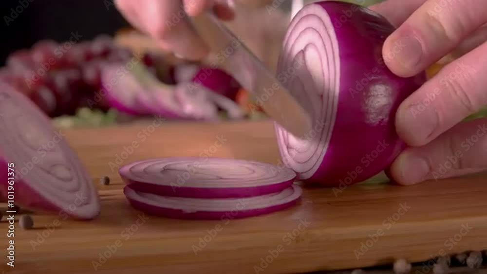 Closeup of red onion quickly cut into slices on chopping board Prores 422 HQ UHD