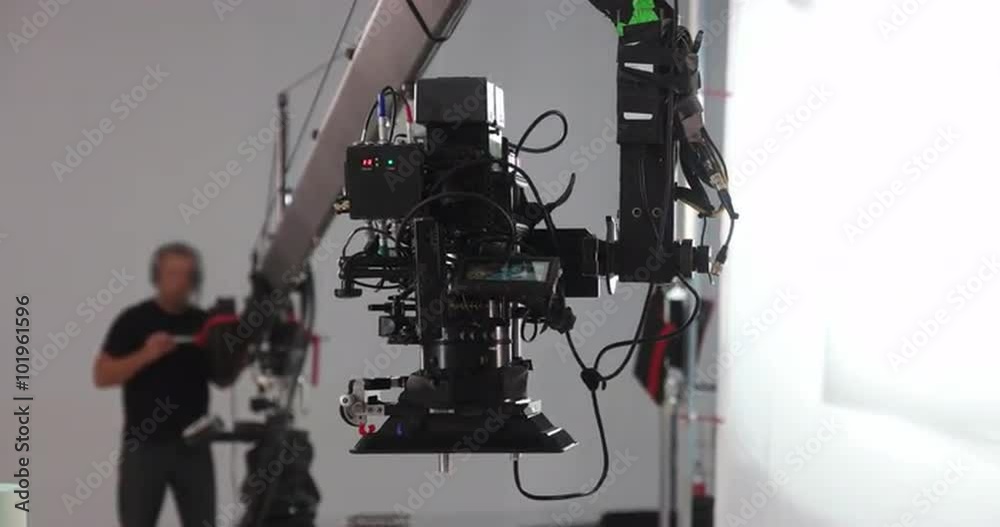 Camera jib operator moving Red Dragon upwards on professional production film set 4K Prores HQ