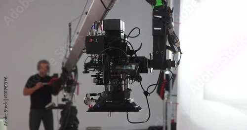 Camera jib operator moving Red Dragon upwards on professional production film set 4K Prores HQ