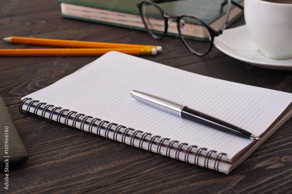 Closeup of open notebook with blank pages and a pen Closeup of open notebook with blank pages and a pen